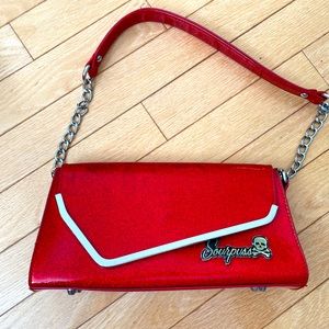Brand new Sourpuss clutch purse. Iridescent red.